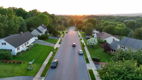 aerial tracking shot of car driving down neighborhood street