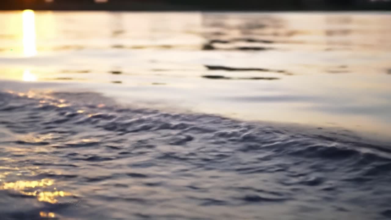 Captivating Reflections: The Tranquil Dance of Water Waves Under the Setting Sun with a Beautiful Captured Light Glimmering on the Surface