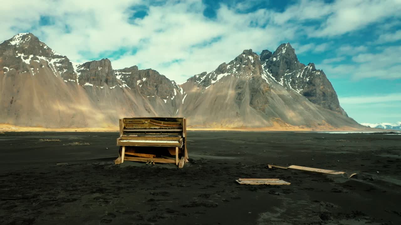 Piano on a black beach in Iceland with Vestrahorn in the background