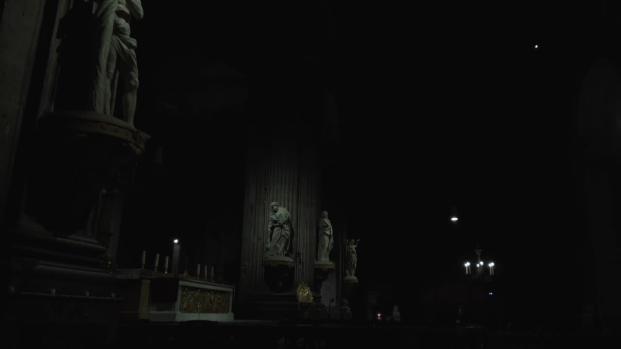 lighten saints statues in a dark old church
