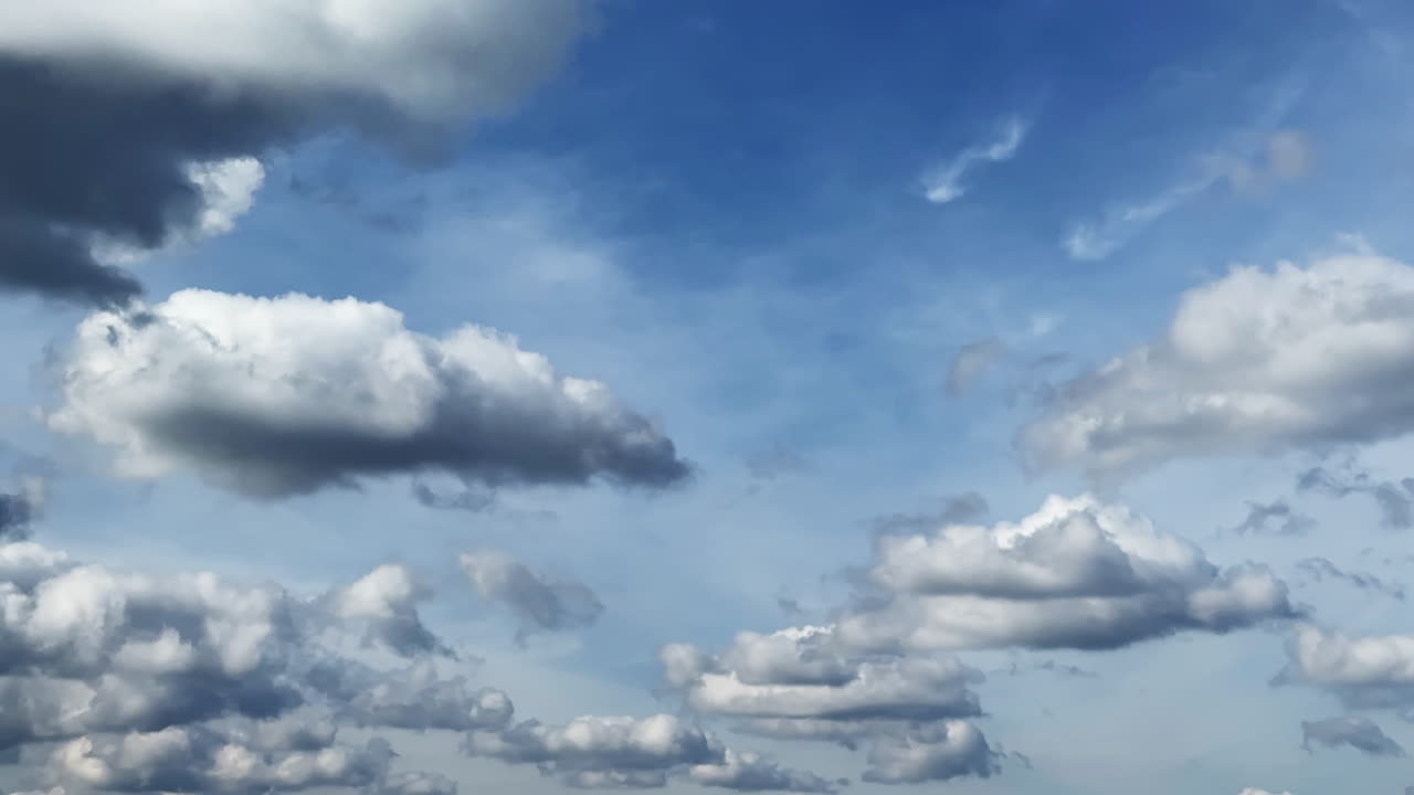Lovely blue sky with a diversity of clouds. Soft fluffy clouds quickly transform in the atmosphere. Timelapse.
