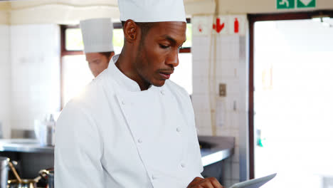 Chef-using-digital-tablet-in-kitchen