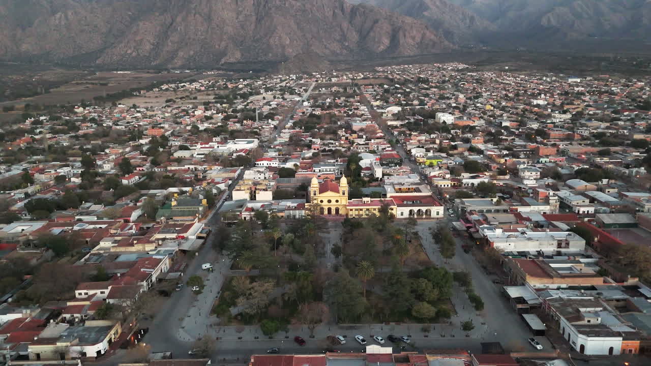 Drone view of a sunrise over Cafayate, with the magnificent Andes Mountains in the background.