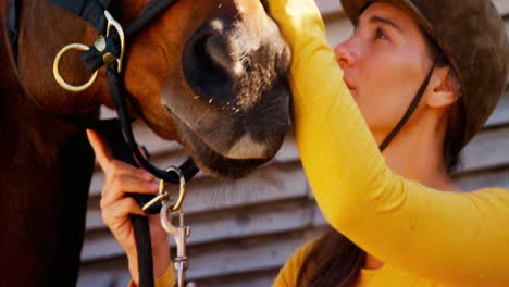 Woman-standing-with-the-horse-in-the-ranch-4k