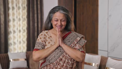 Confident-Indian-aged-woman-showing-victory-sign