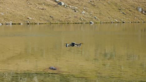 Modern-advanced-drone-flying-over-small-lake