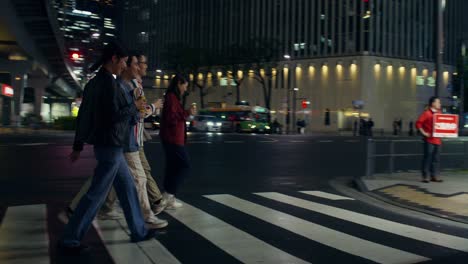 friends walking at night in japan
