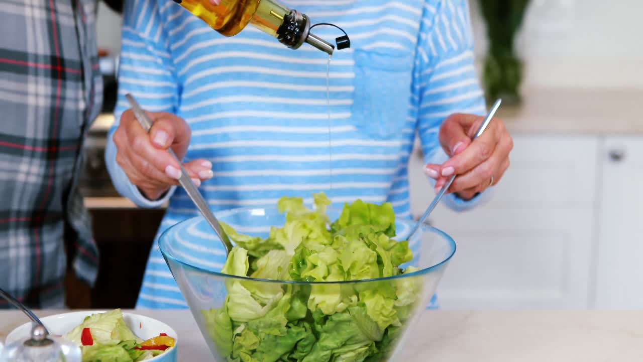 Man and daughter kissing woman on cheeks in living room