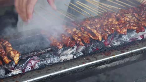 street food vendor grilling satay, grilled meat on skewer