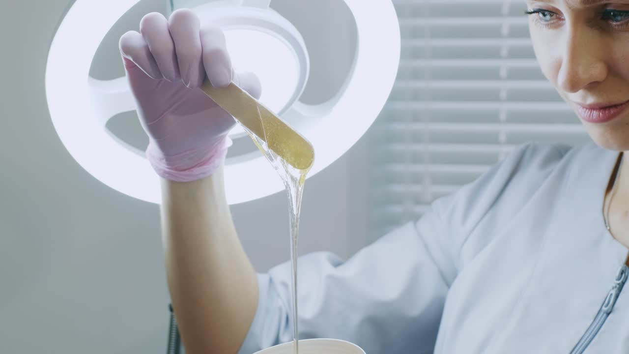 mujer con cabello de azúcar quitando pasta. concepto de belleza. azúcar. proceso de depilación.