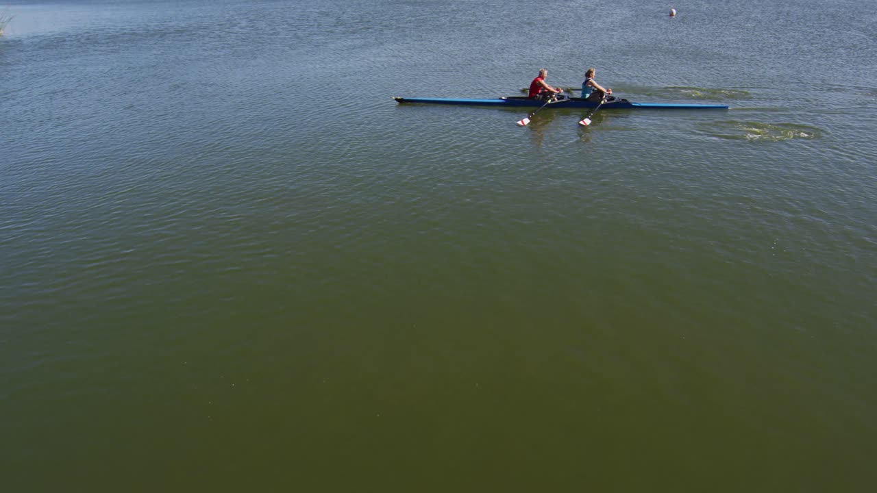 hombre y mujer caucásicos mayores en un barco de remo en un río