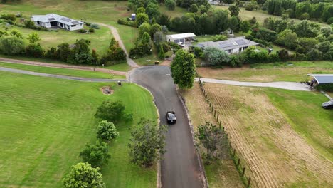 car driving through lush suburban landscape