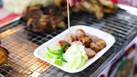 grilled sausages and vegetables at a street food stall