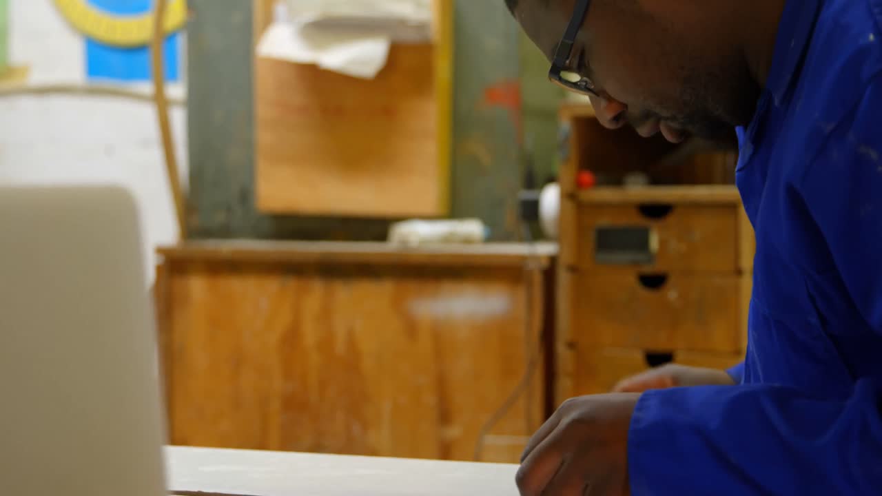 Worker working at table in workshop 4k
