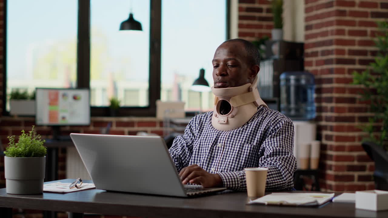 Financial analyst with physical injury wearing medical neck collar