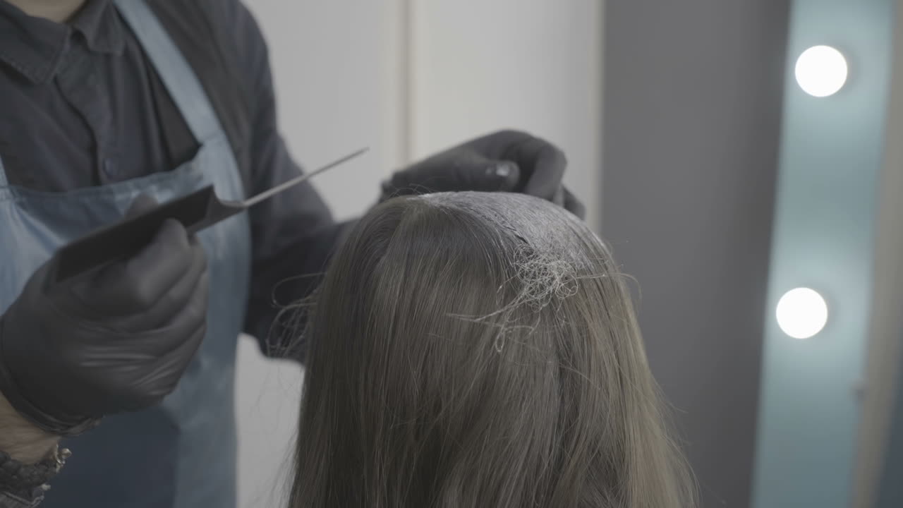 Young woman and hairdresser making styling hair at beaty salon