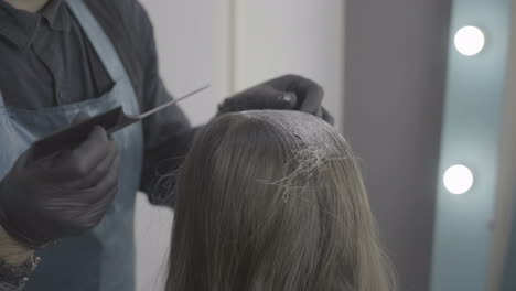 young woman and hairdresser making styling hair at beaty salon