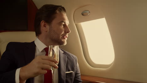 rich man traveling jet drinking campaign closeup. handsome man on romantic date