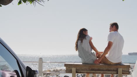 young adult couple relaxing by the sea