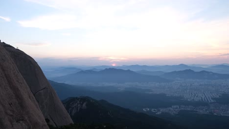 beautiful shot of seoul city skyline with a sunset over the mountains