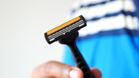 close-up of a person holding a razor