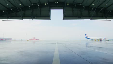 empty airport hangar with airplane