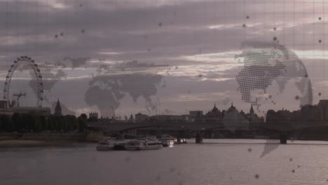Animation-of-world-map-and-spinning-globe-against-aerial-view-of-sea-and-cityscape