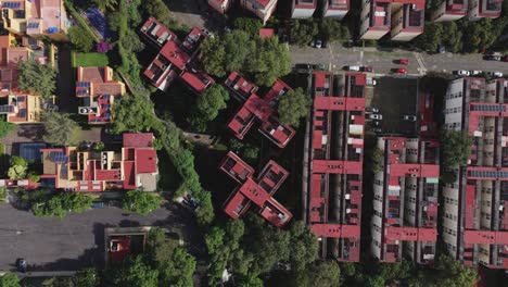 descending drone shot of a housing zone featuring buildings with geometric forms