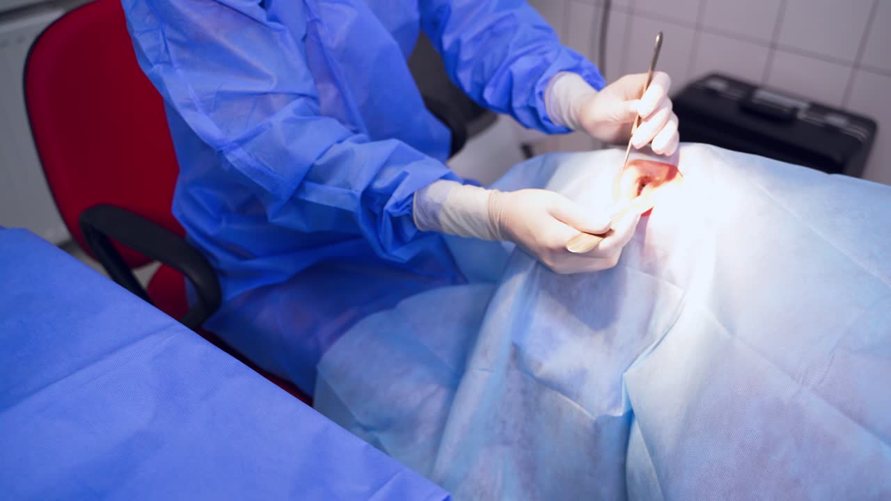 Specialist uses medical instruments during eye surgery. Sterile instruments on the table. Ophthalmologist in latex gloves taking medical tools for operation.