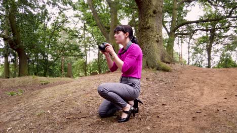 lady photographer taking pictures in the woods