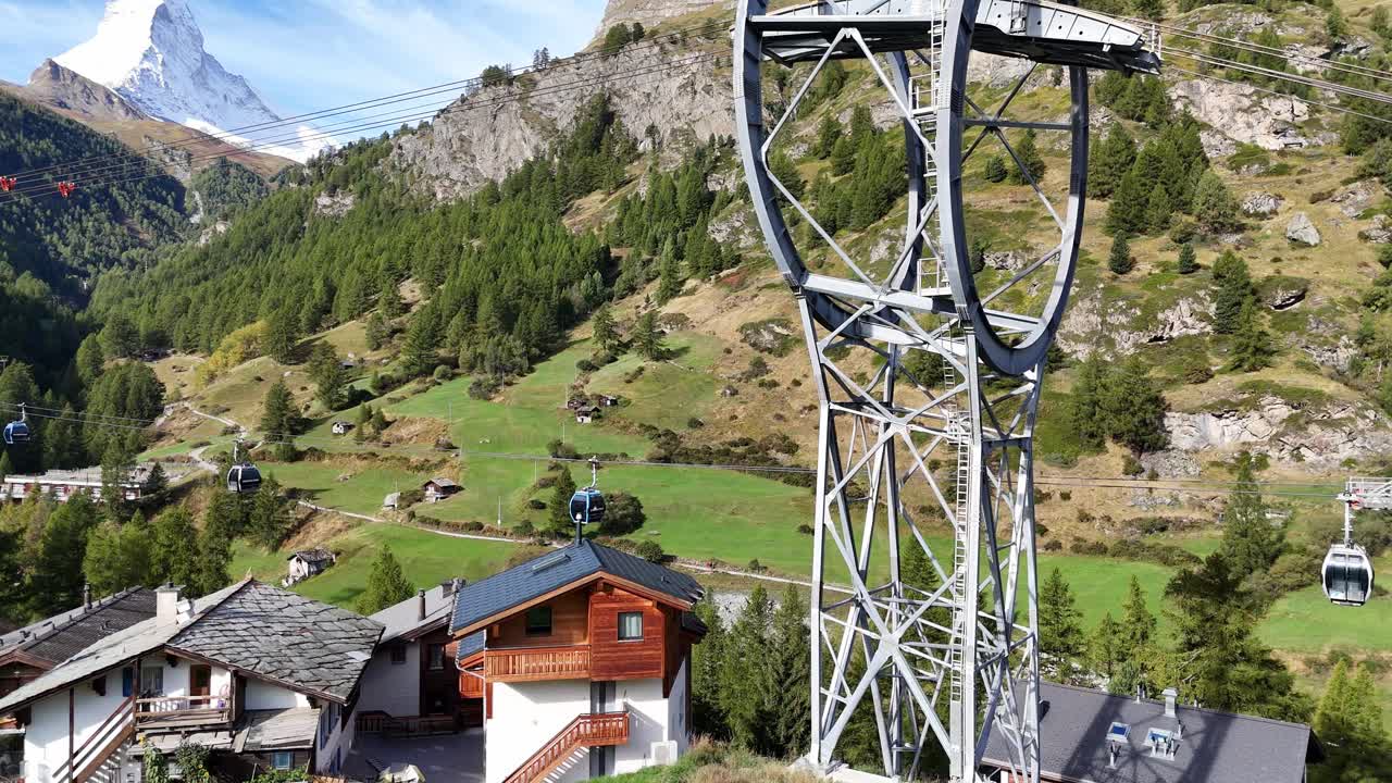 Zermatt, Switzerland, iconic Matterhorn covered in snow and running ski gondolas in this stunning aerial