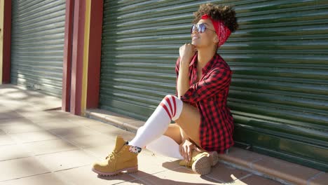 gorgeous african american girl sitting next to fence