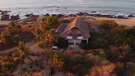 massive sunrise flare as drone rotates around luxury villa with white suv parked in front oaxaca mexico ocean pacific 4k aerial