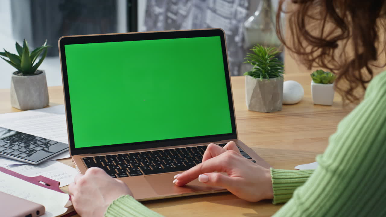 Lady hands swiping chromakey laptop at morning office closeup. Creator working