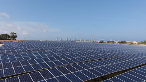 Volando-Rápido-Sobre-Colectores-De-Luz-Solar-En-Una-Granja-Solar-En-Malta---Vista-Aérea