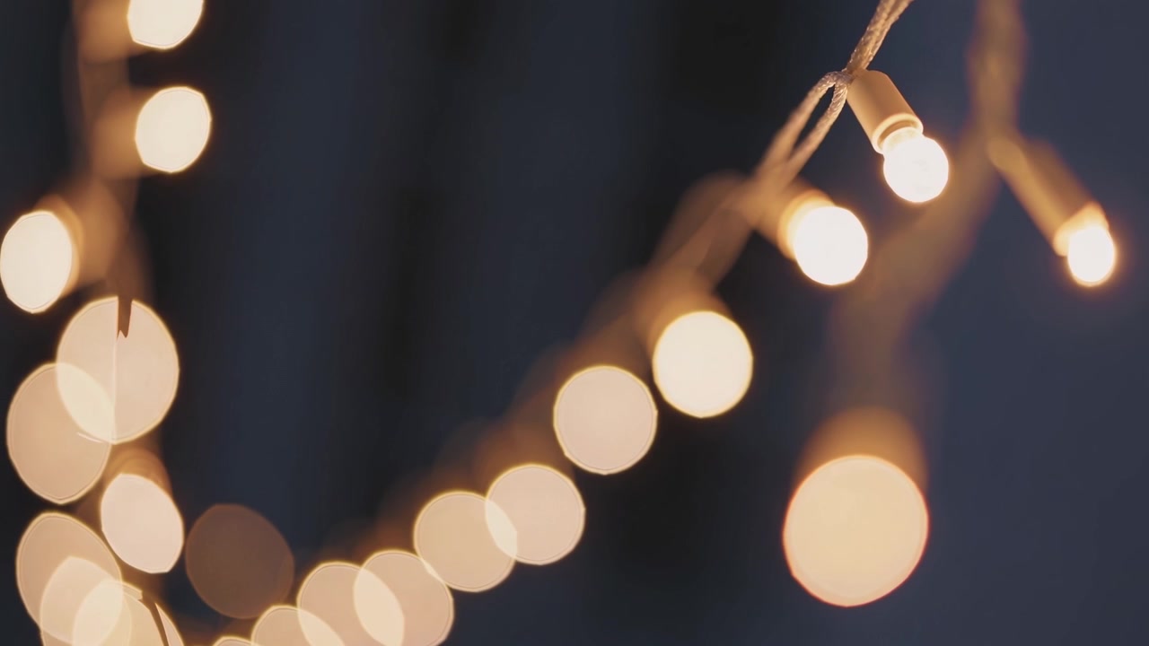 String of Warm Glowing Fairy Lights Against Dark Background