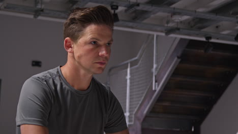 close up portrait of determined male athlete sport training in gym sitting and concentrating in changing room with focused expression 7