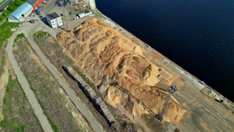 huge piles of sawdust on coast for ship import or export, aerial view