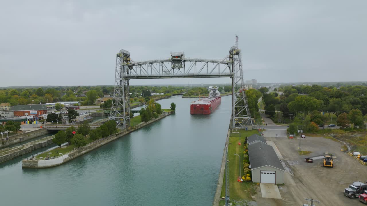 Port Colborne's famous vertical lift bridge on the canal is raised, and a giant laker boat is going down the canal