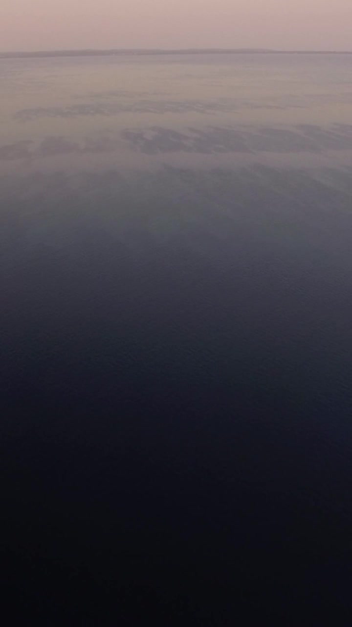 Vast water surface with sailing motor boat