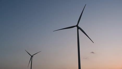 Wind-Turbines-Silhouette-against-the-Blue-sky-during-Sunset,-clean-alternative-energy-in-Thailand-and-mainland-Southeast-Asia