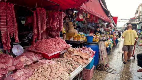 activity at a meat stall in a busy market.