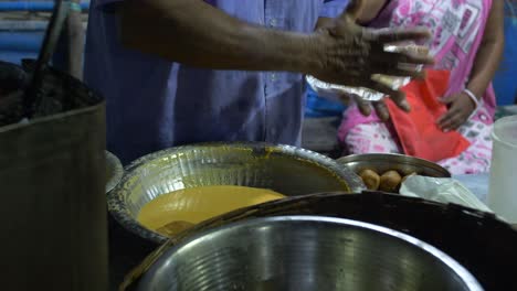 preparing the food to be fried for street sales. india. traditional.