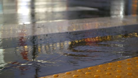 rain drops on wet asphalt of city street in usa, raindrops falling, reflections.