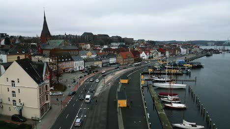 Drone-Flight-over-the-streets,-next-to-the-harbour-of-the-historic-city-in-Flensburg,-Germany