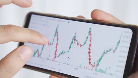 Close-up-male-hands-searching-and-analyzing-stock-market-data.