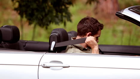 hombre en un coche descapotable