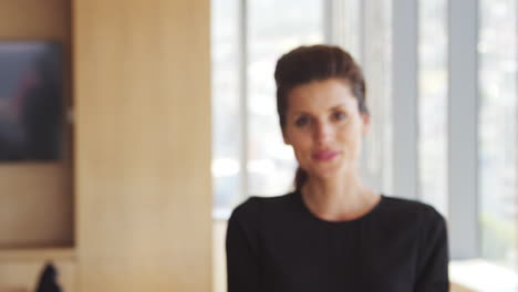 portrait of businesswoman in office walking towards camera