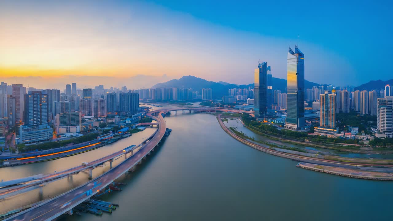 Aerial View of a Modern Cityscape at Twilight with Illuminated Bridges and River