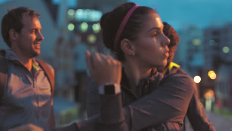 fitness group stretching for a city night jogging